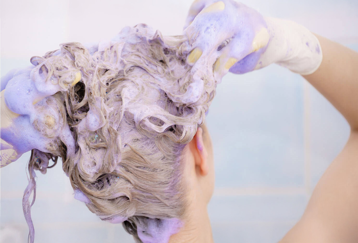 Image of woman using purple shampoo